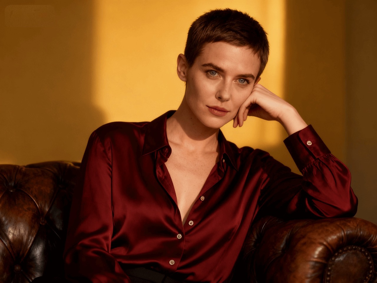 Woman with a buzz cut smiling outdoors