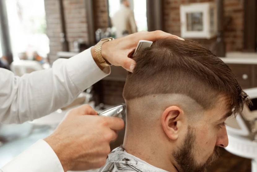 Professional barber reviewing a digital consultation sheet